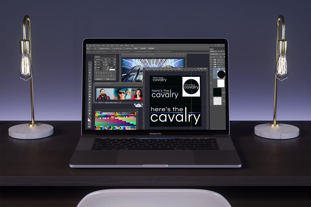 laptop showing open photoshop with here's the cavalry branding