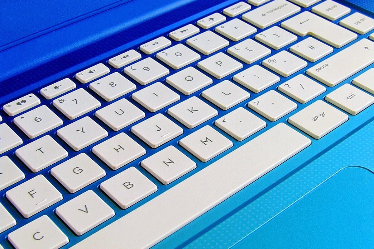 blue laptop with white keyboard